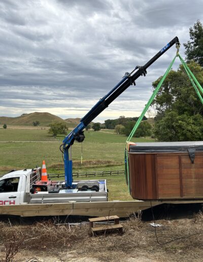 Reach Cranes moving a spa pool into place Hamilton