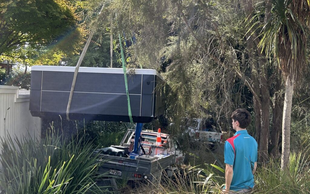 Spa pool movers Hamilton moving a spa pool into tight spot