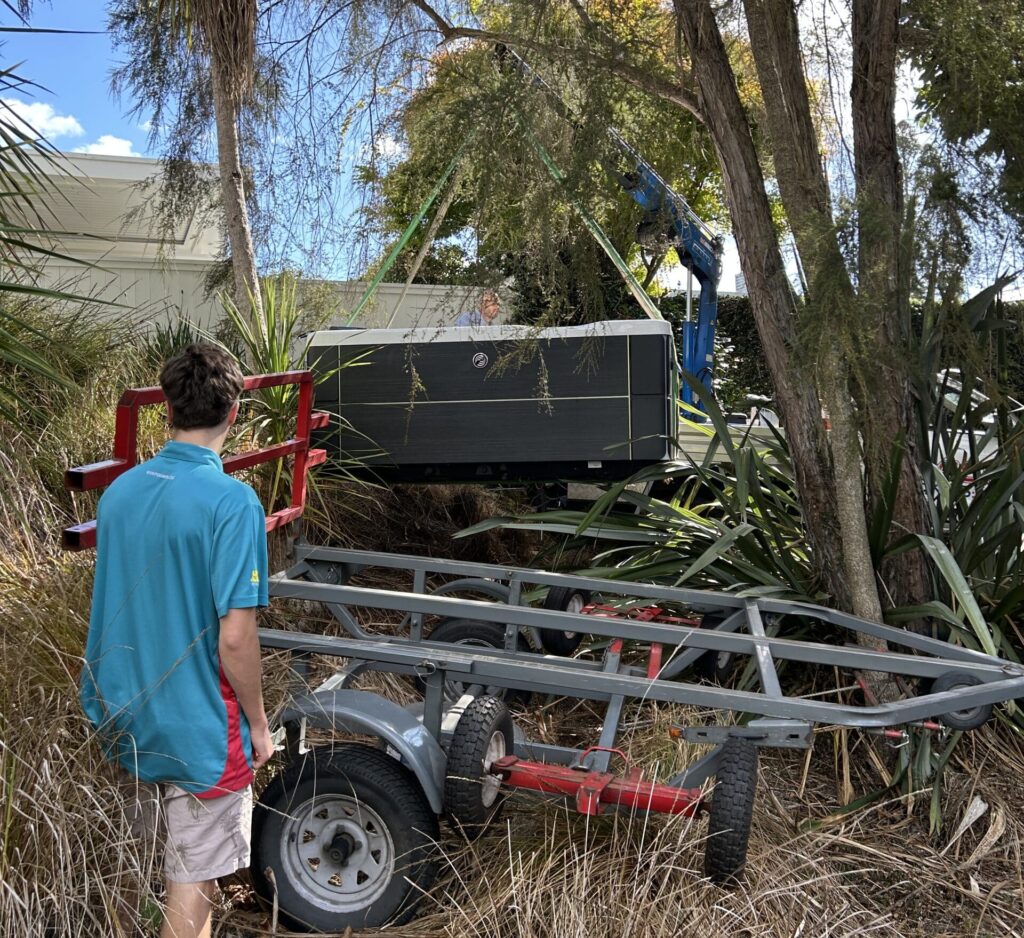 Lowering a spa pool onto the trailer in the bush