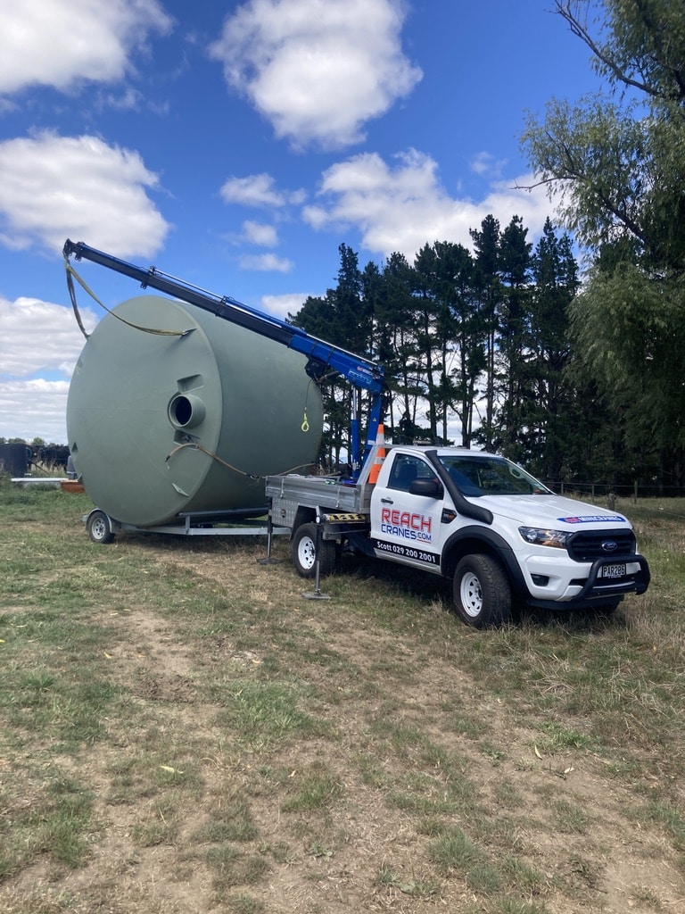 During the delivery stage, our mini Hiab gently lowers and positions one of the 30,000L water tanks from the trailer to its final position.