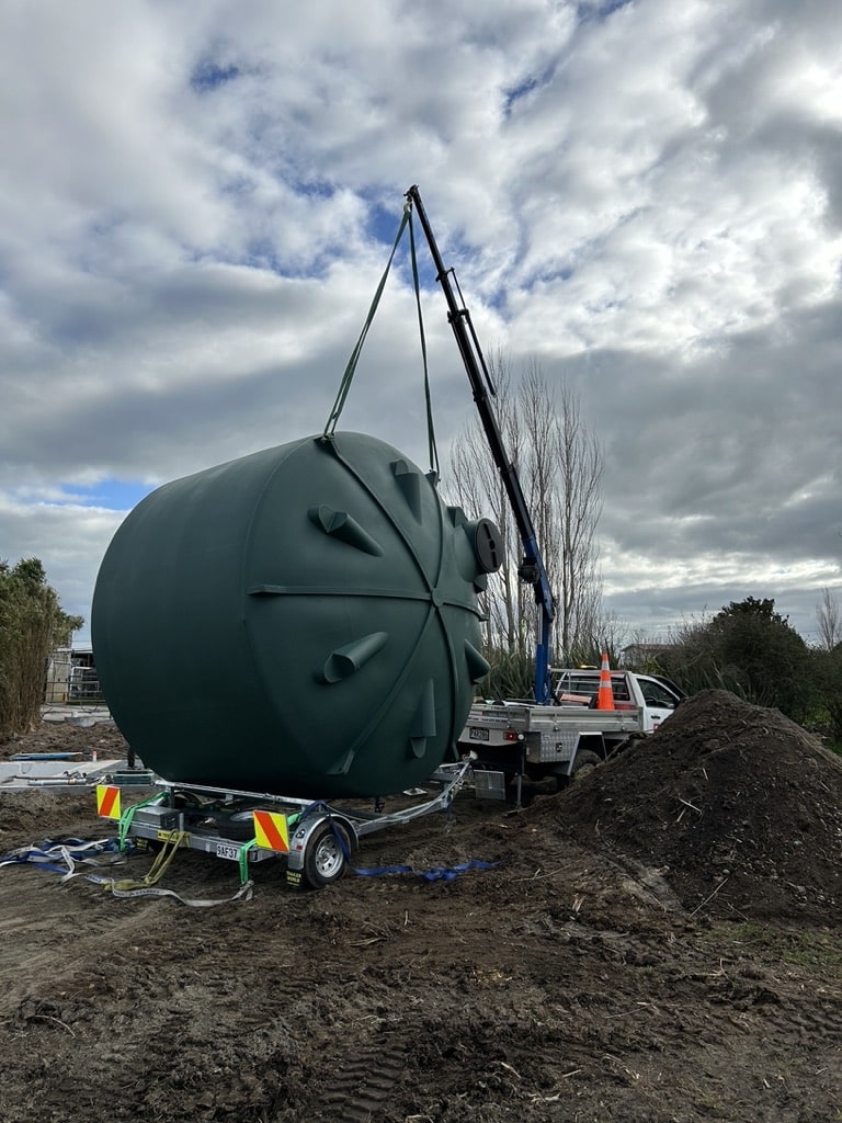Our mini Hiab and trailer set-up on a muddy site during the smooth delivery of a large water tank.